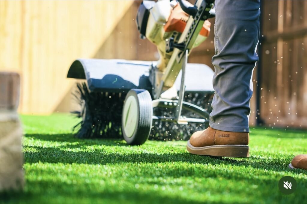 Power broom cleaning artificial turf