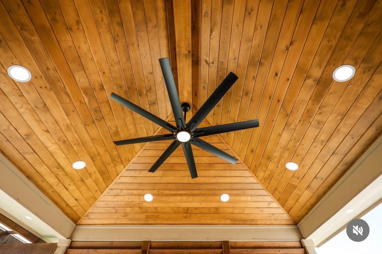 Black ceiling fan under a tongue-and-groove cedar patio cover in San Antonio