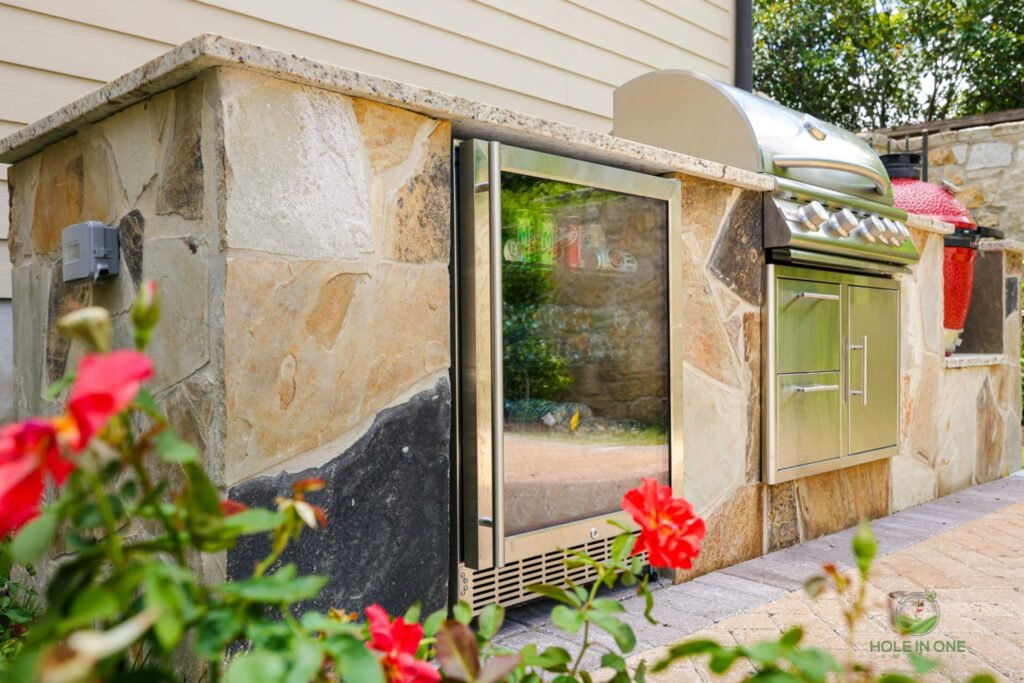 Outdoor kitchen with grill and fridge
