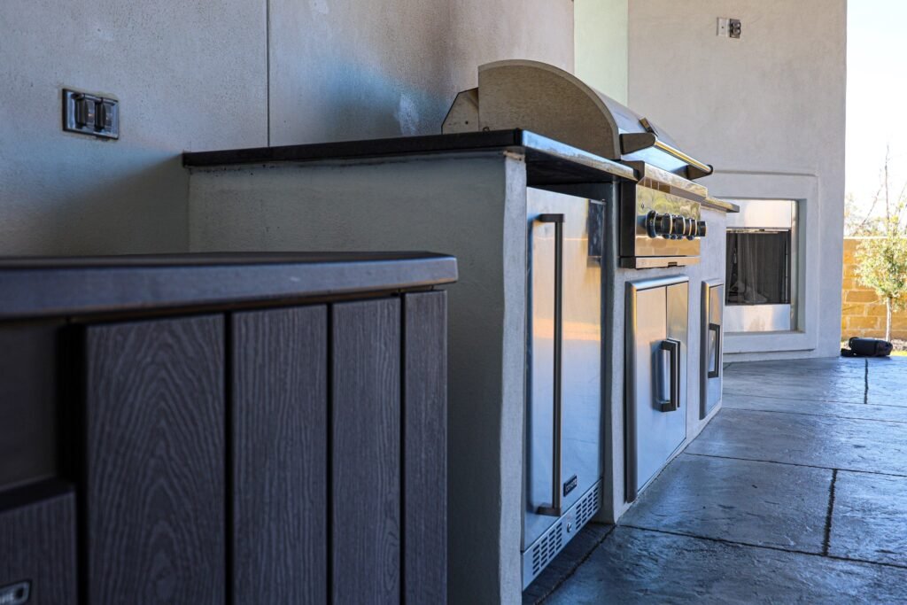 Covered outdoor kitchen with grill and storage