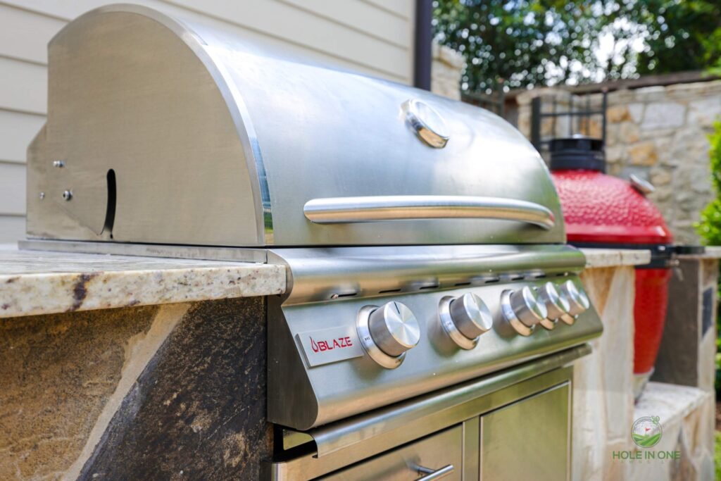 Outdoor stainless steel grill in backyard kitchen