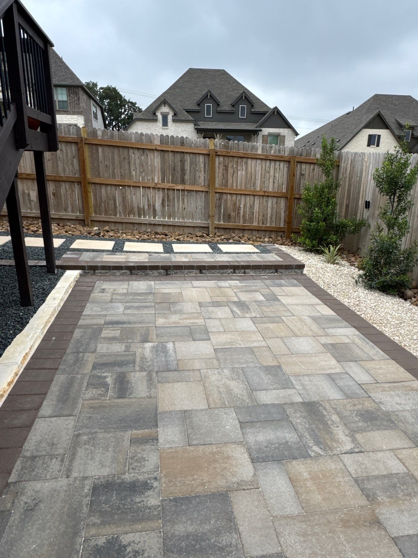 Multi-tone paver patio with a dark soldier-course border in Boerne, TX