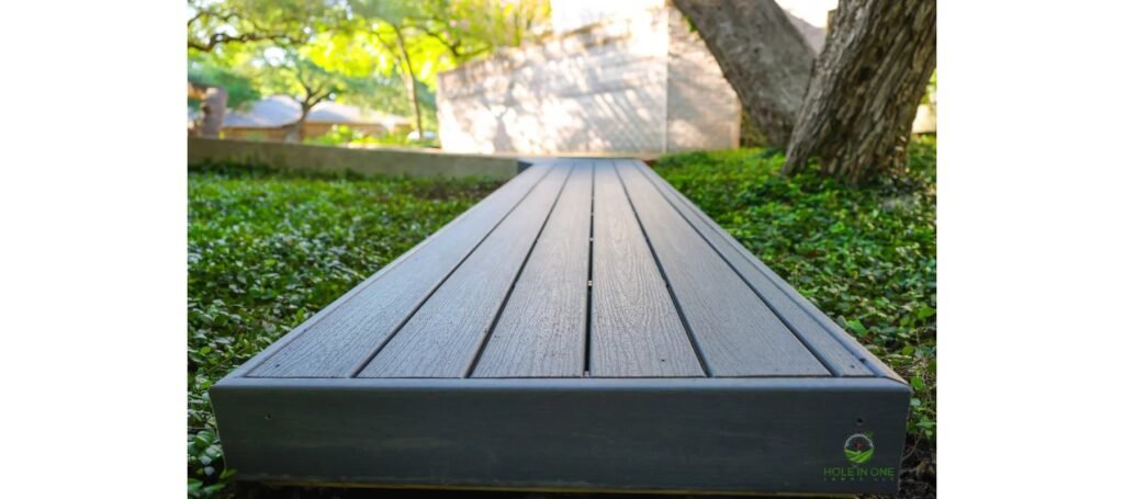 Trex composite walkway winding to a gated entry under a live oak